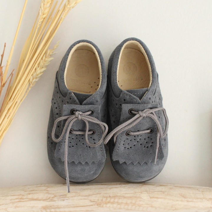 Grey suede Shoes with flexible rubber sole and fringes.